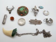 A hallmarked silver brooch with applied gold bird decoration reading 'best wishes',