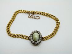 A 19thC 18ct gold French curb link bracelet set with a chrysoberyl cat's eye cabochon surrounded by
