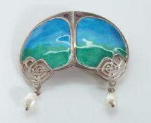 A silver brooch set with green and blue enamel with two drop pearls by Liberty and Co,
