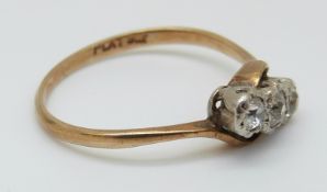 A 9ct gold ring set with three diamonds in a platinum twist setting, 2.