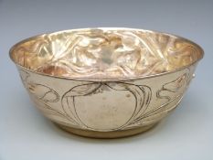A silver plated or similar bowl with floral decoration,