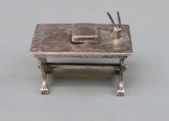 A white metal novelty codice, pens and table, marked with Medusa-Oro star and 175 AR 925,