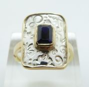 An 18ct bi-coloured gold ring set with an emerald cut sapphire, size R/S, 7.