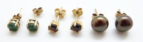 Two pairs of 9ct gold earrings, one set with emeralds and the other garnets,