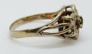 A 9ct gold ring set with a sapphire surrounded by diamonds in a cluster, size K/L, 2.