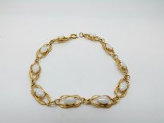 A 9ct gold bracelet set with white opals, 5.