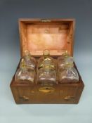 A Georgian mahogany travelling case of six gilt apothecary or similar bottles, each 20cm tall,