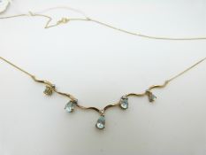 A 9ct gold necklace set with pear cut blue topaz and diamonds