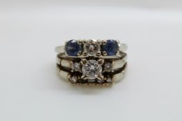 An 18ct white gold three band ring set with a round brilliant cut diamond of approximately 0.