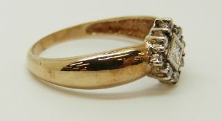 A 9ct gold ring set with a square cut diamond surrounded by round cut diamonds, 2.