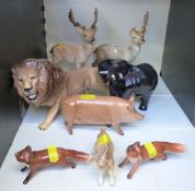 A collection of Beswick animal figures to include lion, deer, elephant, kid goat,