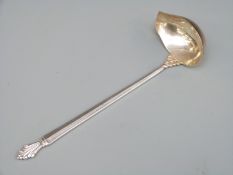 A Georg Jensen hallmarked silver sauce ladle with GI and 925.