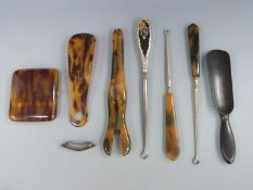A hallmarked silver and tortoiseshell button hook and a quantity of faux tortoiseshell and similar