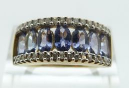 A 9ct gold ring set with tanzanites and diamonds, size O/P, 3.