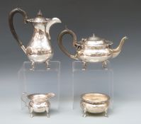 A George V hallmarked silver four piece tea service comprising teapot, hot water jug,