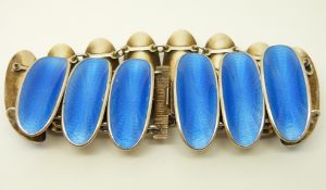 A silver bracelet set with blue guilloché enamel in oval panels by David Andersen,
