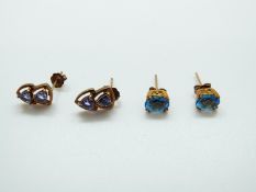 A pair of 9ct gold earrings each set with two tanzanites and a pair of 9ct gold earrings set with a