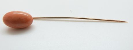 A Victorian stick pin set with a coral cabochon