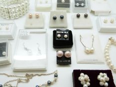 A collection of pearl items, including a silver necklace set with pearls, bracelet,