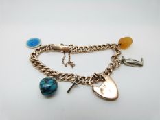 A 9ct gold curb link bracelet with turquoise charm, a 9ct gold heart padlock etc,