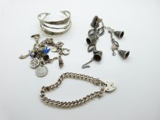 A silver charm bracelet with enamel bird charm, silver mermaid, silver car etc,