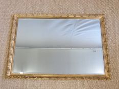 A bevelled glass mirror with decorative gilt moulded frame,