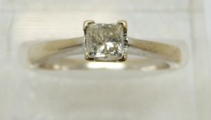 An 18ct white gold ring set with a princess cut diamond of approximately 0.