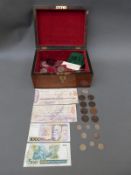 A wooden chest / caddy containing some crown sized coins including silver Britannia,