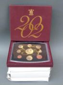 Four Royal Mint deluxe proof coin sets for 1997, 1999, 2001 and 2002,