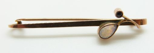 A 9ct gold brooch set with a pear cut opal and a ruby,