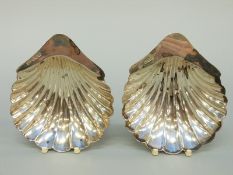 A pair of Edward VII hallmarked silver shell shaped three footed bonbon dishes,