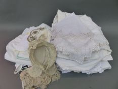 A collection of linen to include Edwardian petticoats, aprons, bonnets etc,