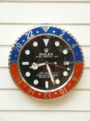 Rolex advertising wall clock with blue and red bezel surround,