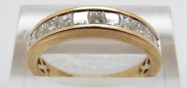 An 18ct gold ring set with 11 princess cut diamonds, size O, 4.