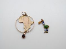 A 9ct gold charm in the form of a comical bird set with enamel and a 9ct gold pendant in the form