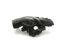 A Victorian jet brooch in the form of a hand and wreath