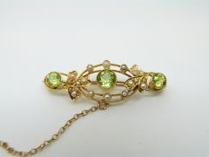 A 15ct gold Edwardian brooch set with peridot and seed pearls