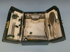 An Edward VII leather cased travelling vanity case fitted with five hallmarked silver topped