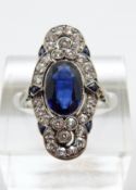 An Art Deco platinum ring set with an oval cut synthetic sapphire of approximately 2ct surrounded