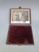 A leather cased daguerreotype or similar early photograph of a family group, size of photo 8.