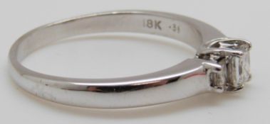 An 18ct gold ring set with three princess cut diamonds totalling approximately 0.