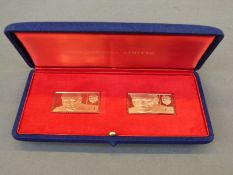 A pair of Metalimport Ltd 18ct gold Sir Winston Churchill stamp replicas in presentation case with