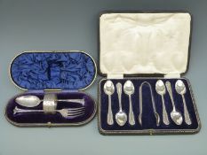 A cased set of six hallmarked silver teaspoons and tongs and a further cased christening set