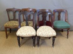 A harlequin set of six Victorian carved back dining chairs