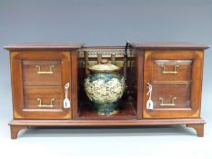 An Edwardian inlaid mahogany twin pedestal smoker's cabinet with brass rail,
