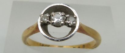 An 18ct gold ring set with three diamonds in a platinum setting, size M, 3.