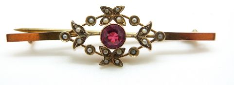A 9ct gold ring set with red paste surrounded by seed pearls, 3.