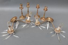A brass candelabra and a set of four bronze or similar candlesticks