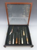 A display of ten various button hooks including a jet handled example