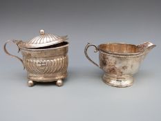 A hallmarked silver milk jug, Birmingham 1933 and mustard holder, Birmingham 1893,